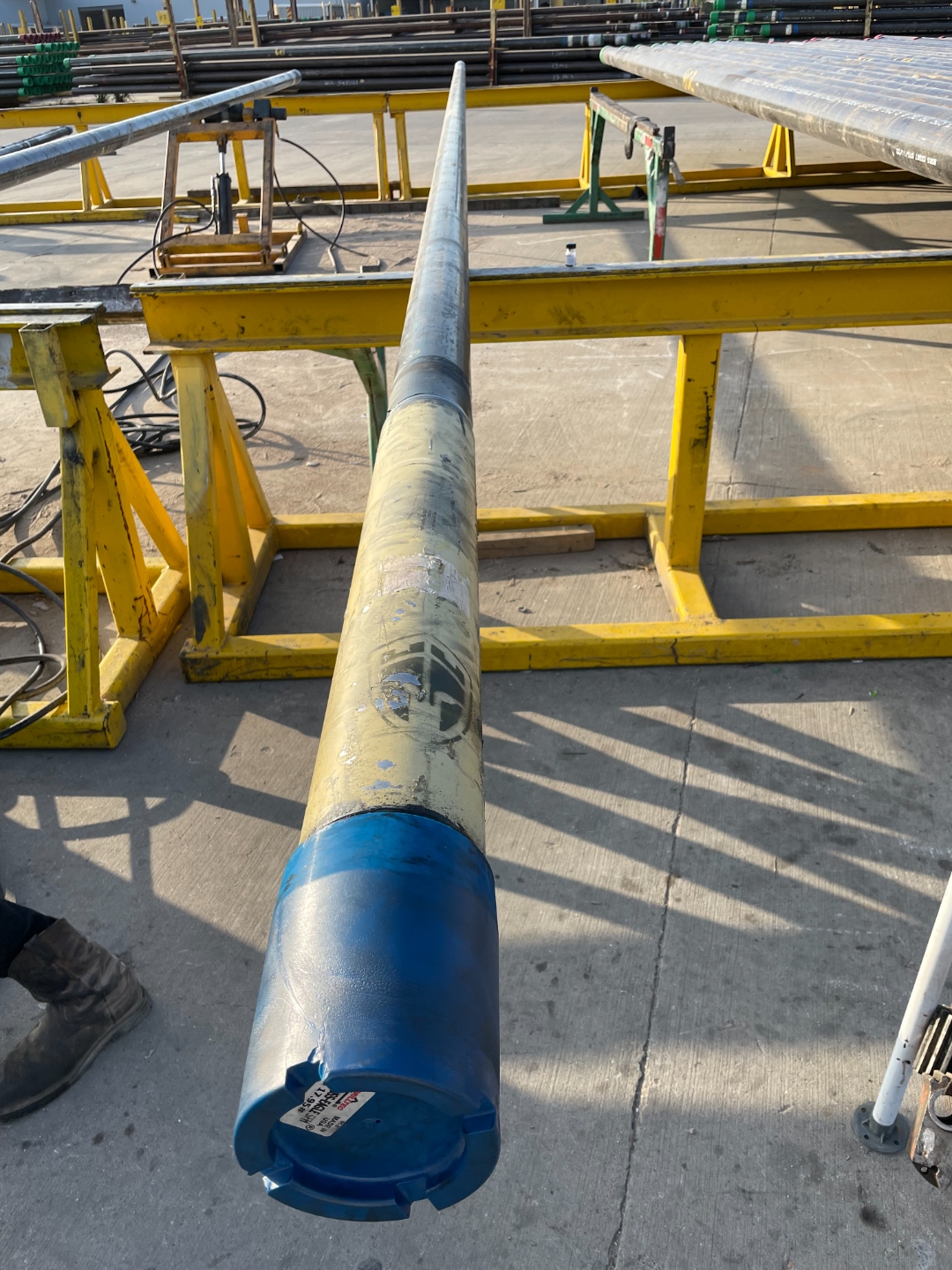Coupling and protector bucked onto a casing joint at a Delta Solutions staging yard