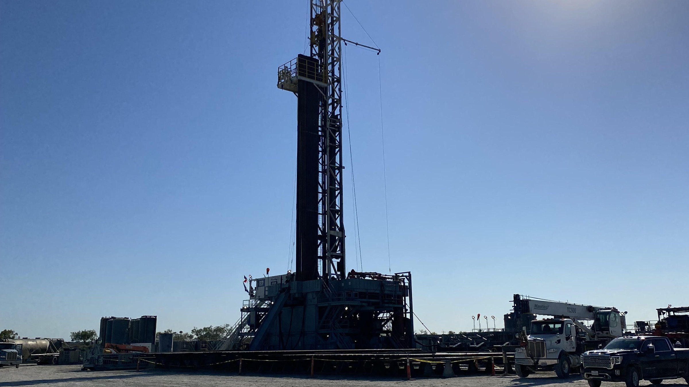 Delta Solutions field team on location with a service rig and crane truck in Texas