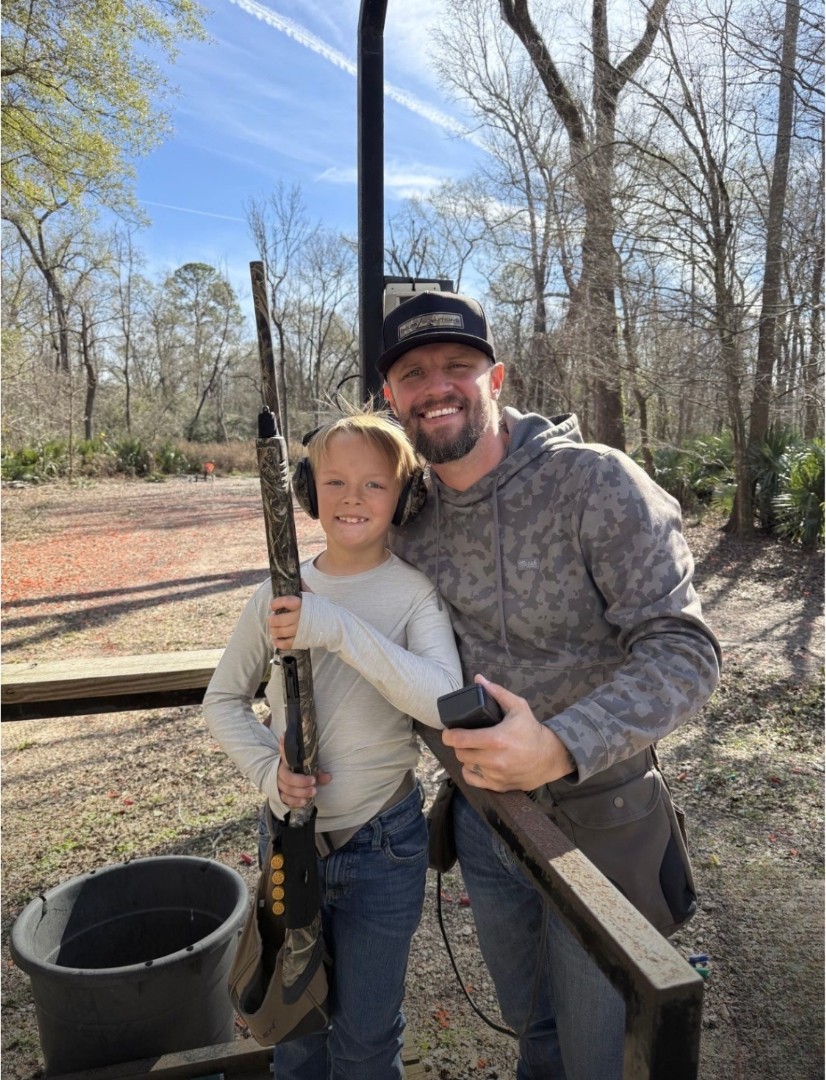 A father and son at a sporting clays event supported by Delta Solutions