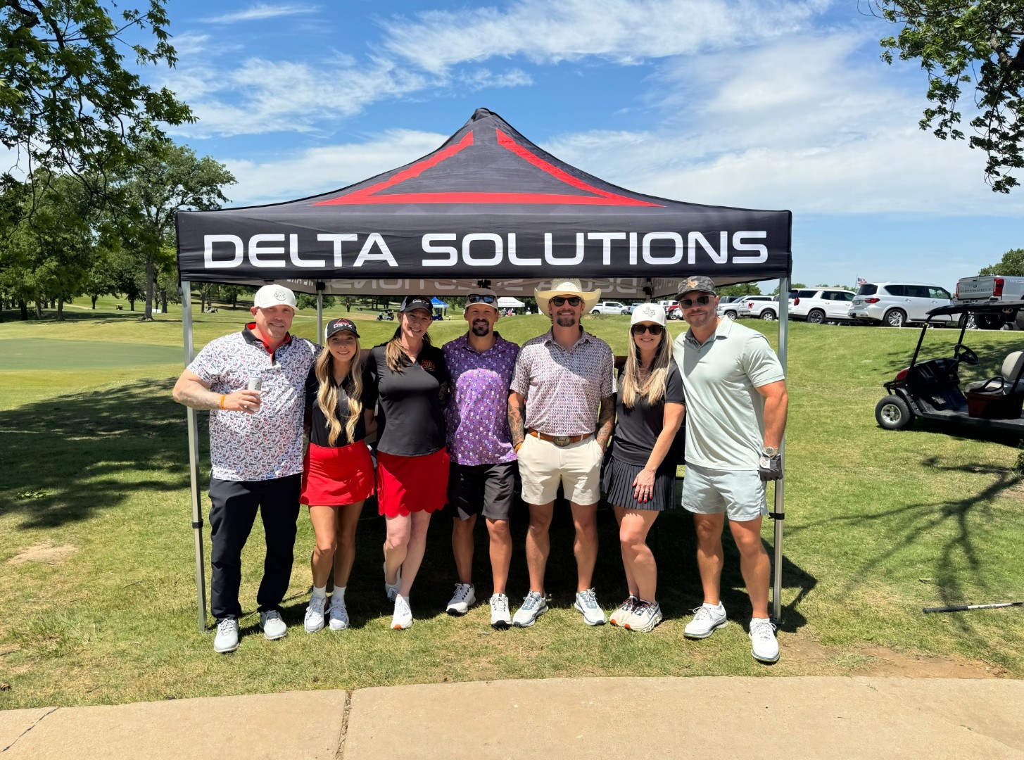 Delta Solutions team at a charity golf tournament tent