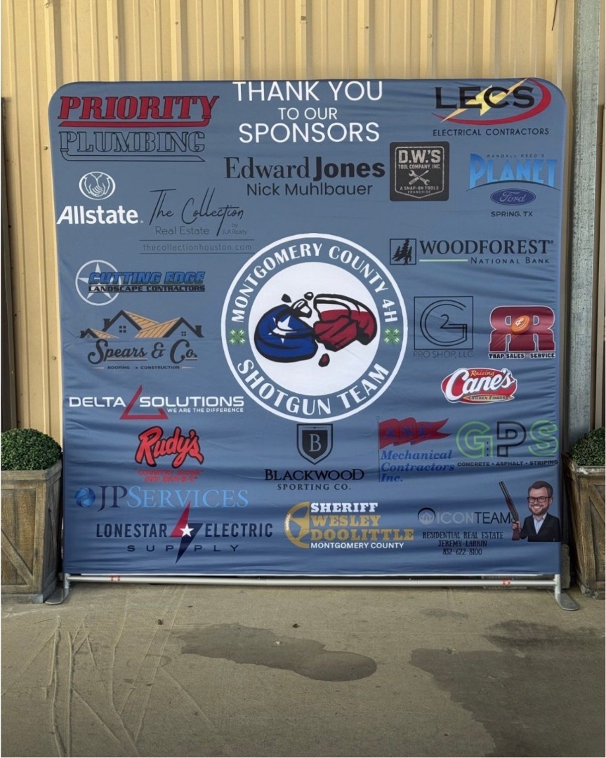 A sponsor recognition board featuring Delta Solutions at a community shooting event