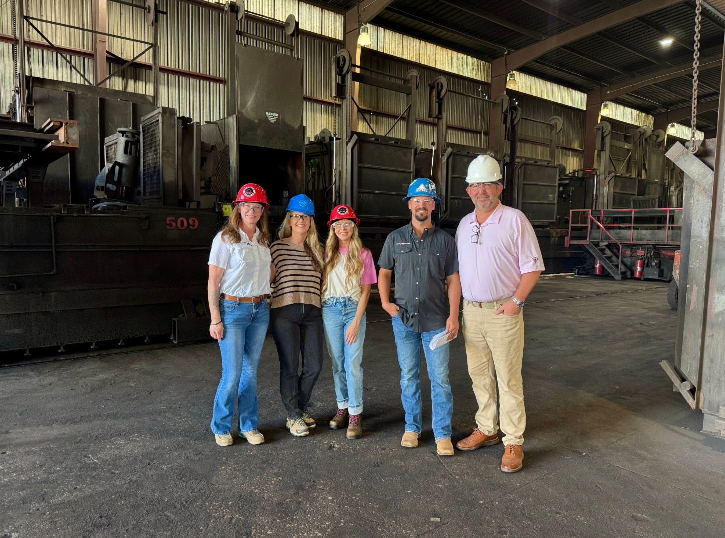 Delta Solutions team touring a partner facility in hard hats