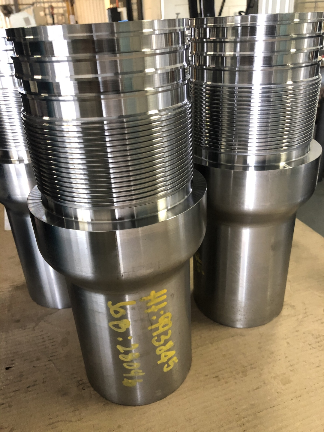 CNC-turned casing crossovers with premium threads staged on the Delta Solutions shop floor