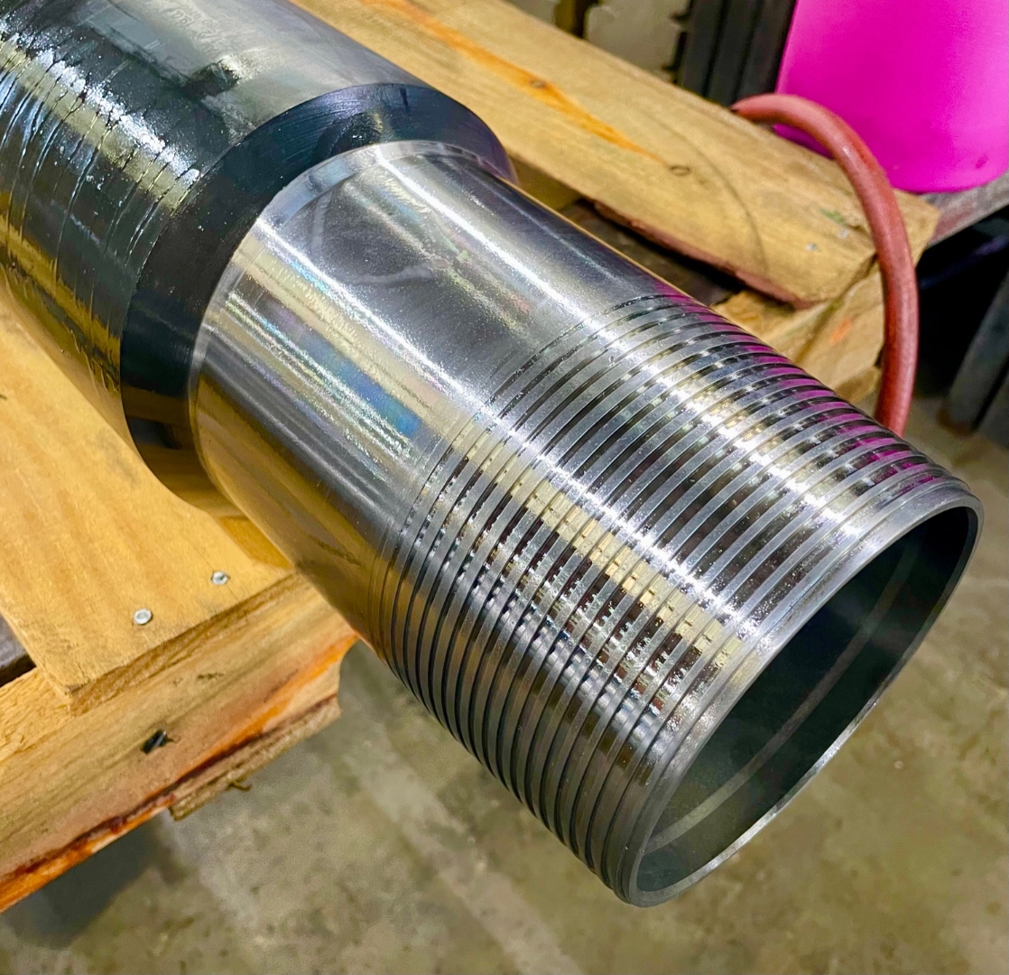 Close-up of freshly cut premium threads on a casing pin end at Delta Solutions
